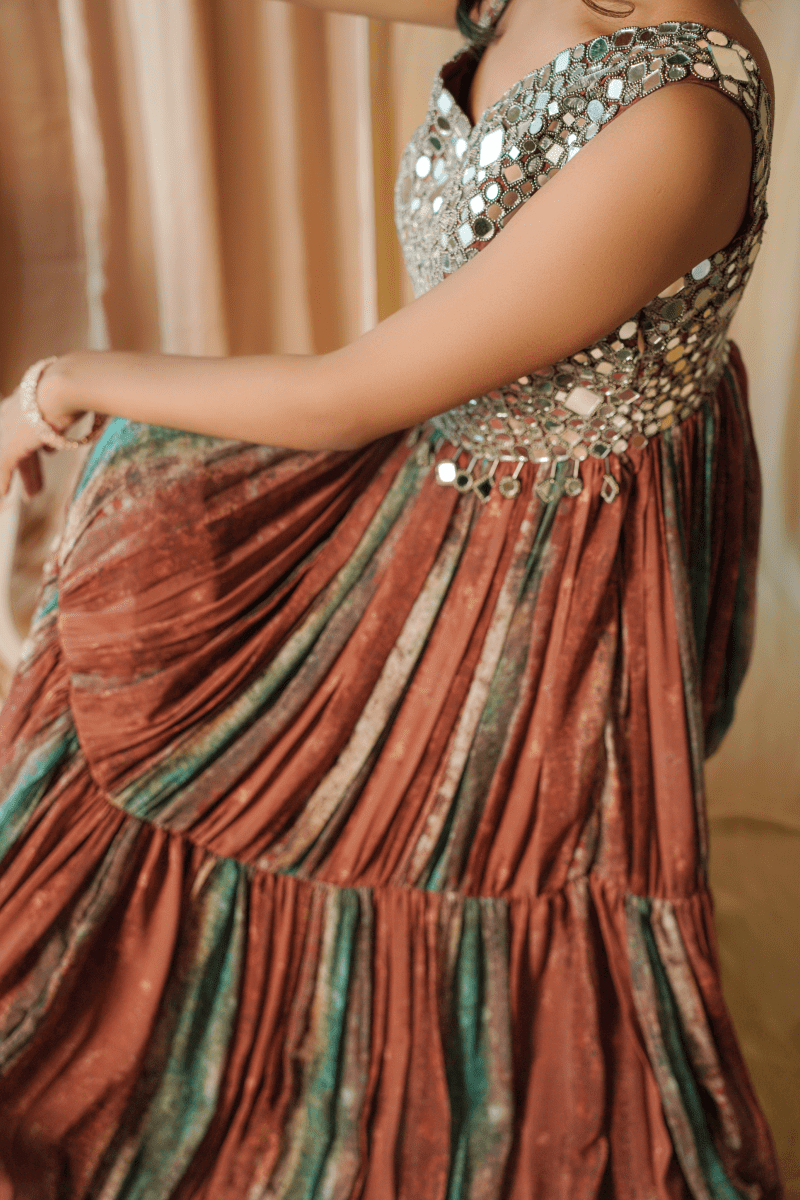 The Brown Frill Printed Long Length Gown with Tassels and Latkan is a  stylish and elegant